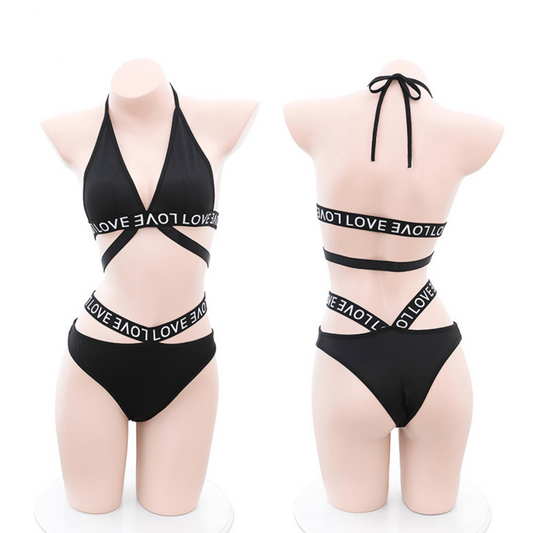 Black bikini set with 'LOVE' text on a white background, featuring the brand 'Fé Et Moi'.